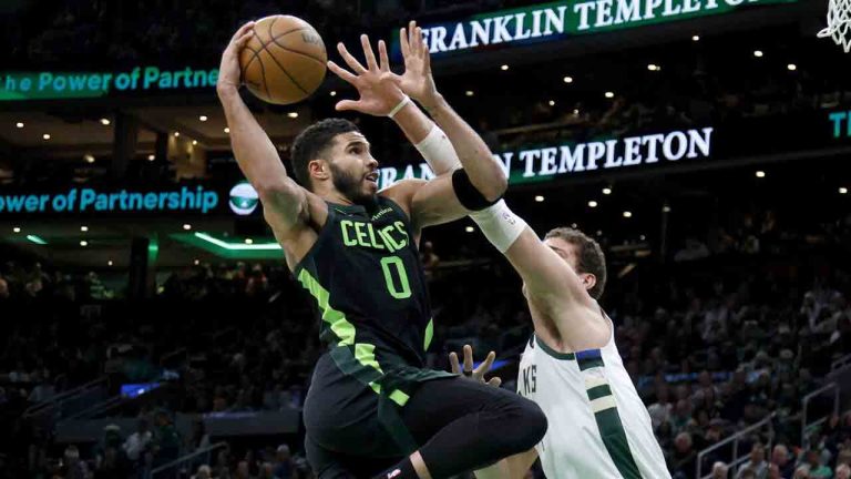 Boston Celtics forward Jayson Tatum (0) drives to the basket against Milwaukee Bucks center Brook Lopez (11) during the first half of an NBA basketball game, Friday, Dec. 6, 2024, in Boston. (Mary Schwalm/AP)