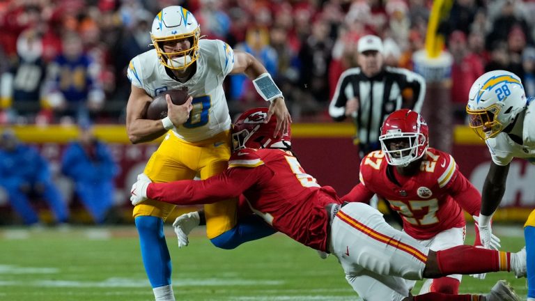 Los Angeles Chargers quarterback Justin Herbert runs against Kansas City Chiefs defensive end Mike Danna (51) during an NFL football game Sunday, Dec. 8, 2024, in Kansas City, Mo. (Ed Zurga/AP)