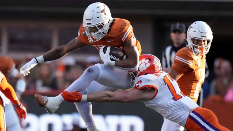 Texas running back Jaydon Blue (23) tries to break a tackle by Clemson linebacker Wade Woodaz (17) during the first half in the first round of the College Football Playoff, Saturday, Dec. 21, 2024, in Austin, Texas. (Eric Gay/AP Photo)