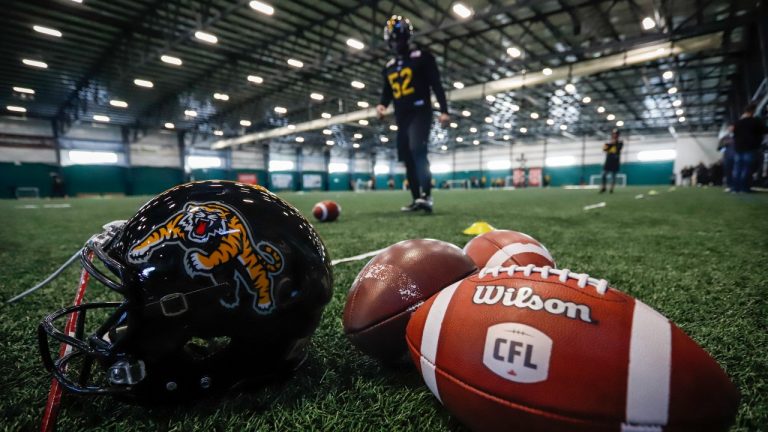 Balls and a helmet sit on the turf during Hamilton Tiger-Cats practice for the CFL Grey Cup in Calgary, Wednesday, Nov. 20, 2019. (Jeff McIntosh/THE CANADIAN PRESS)