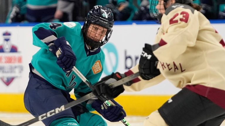 New York's Jill Saulnier (44) is defended by Montreal's Erin Ambrose (23) during the first period of a PWHL hockey game. (AP Photo/Frank Franklin II)