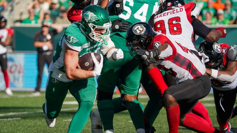 Saskatchewan Roughriders running back Thomas Bertrand-Hudon (30) runs the football as Ottawa Redblacks linebacker Davion Taylor (43) defends during the second half of CFL football action in Regina, on Saturday, September 28, 2024. (Heywood Yu /CP)