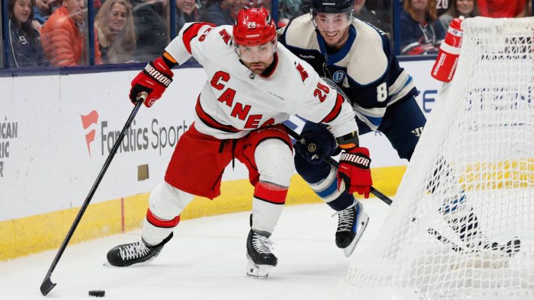 Carolina Hurricanes' William Carrier, left, keeps the puck away from Columbus Blue Jackets' Zach Werenski during the third period of an NHL hockey game Tuesday, Dec. 31, 2024, in Columbus, Ohio. (AP/Jay LaPrete)