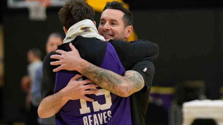 Los Angeles Lakers NBA basketball head coach JJ Redick, right, is hugged by guard Austin Reaves, left before talking to the media about the Pacific Palisades wildfire at a news conference in El Segundo, Calif., Friday, Jan. 10, 2025. (Damian Dovarganes/AP)