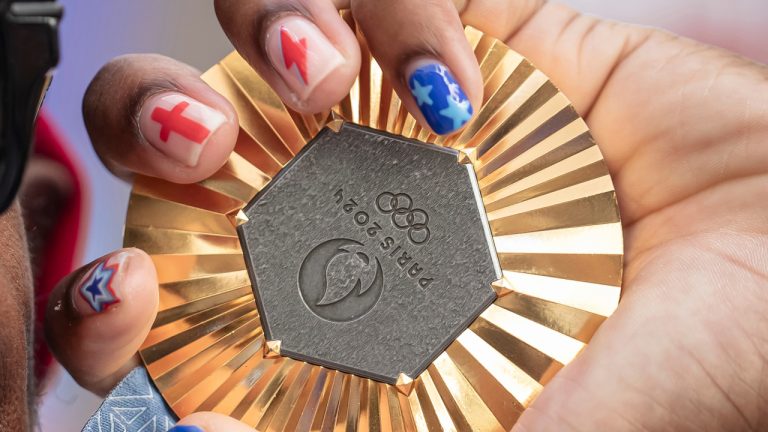 American Olympic champion Noah Lyles holds this gold medal before an interview in Paris, France, Sunday, Aug. 11, 2024. (AP Photo/Aurelien Morissard, File)