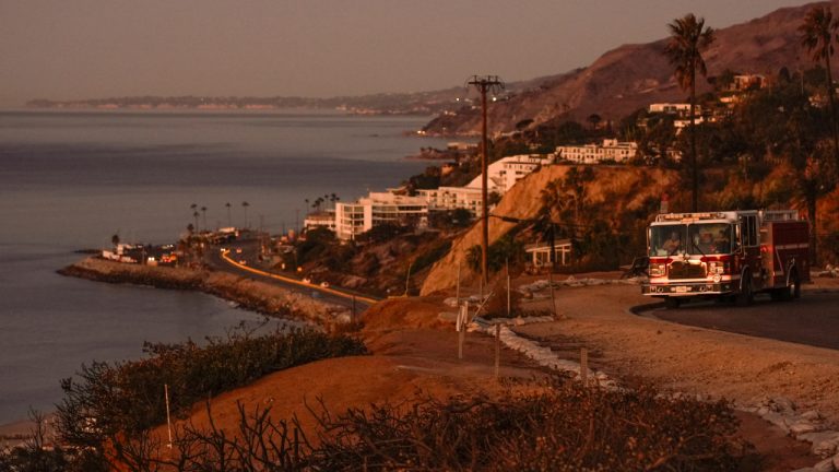 Travis County, Texas Fire Engine 102 is stationed at the Asiliomar Bluffs as the sun rises over homes destroyed by the Palisades Fire in the Pacific Palisades neighborhood of Los Angeles, Thursday, Jan. 16, 2025. (AP Photo/Damian Dovarganes)