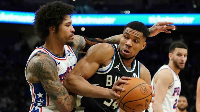 Milwaukee Bucks' Giannis Antetokounmpo, front right, drives to the basket against Philadelphia 76ers' Kelly Oubre Jr., left, during the second half of an NBA basketball game Sunday, Jan. 19, 2025, in Milwaukee. (Aaron Gash/AP)