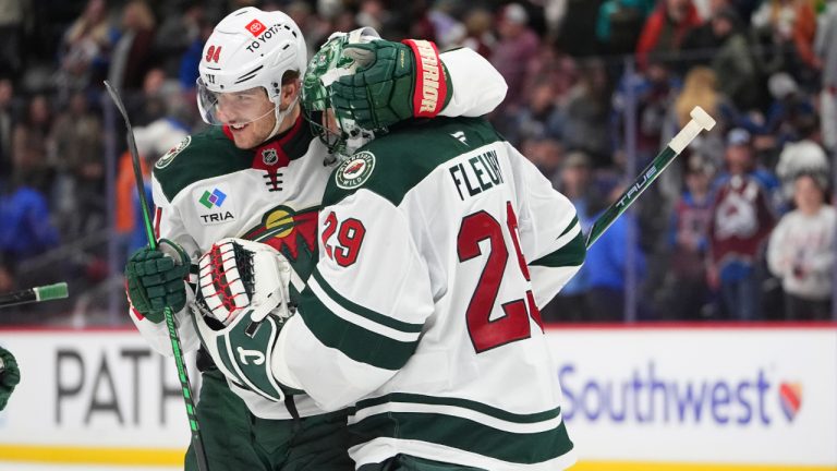 Minnesota Wild's Jakub Lauko congratulates goaltender Marc-Andre Fleury after the Wild's victory over the Colorado Avalanche in an NHL game Monday, Jan. 20, 2025, in Denver. (AP Photo/David Zalubowski)