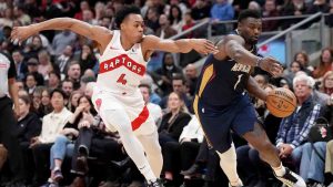 New Orleans Pelicans forward Zion Williamson drives past Toronto Raptors forward Scottie Barnes during first-half NBA action in Toronto on Monday, Jan. 27, 2025. (Nathan Denette/CP)
