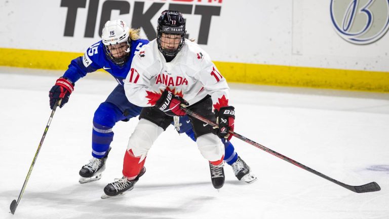 U.S. Savannah Harmon (15) chases Canada's Ella Shelton (17) during the second period of a women's Rivalry Series hockey game. (AP Photo/Kyle Green)