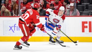 Montreal Canadiens left wing Juraj Slafkovsky, right, keeps the puck away from Detroit Red Wings defenceman Albert Johansson during the first period of an NHL hockey game, Thursday, Jan. 23, 2025, in Detroit. (Jose Juarez/AP)