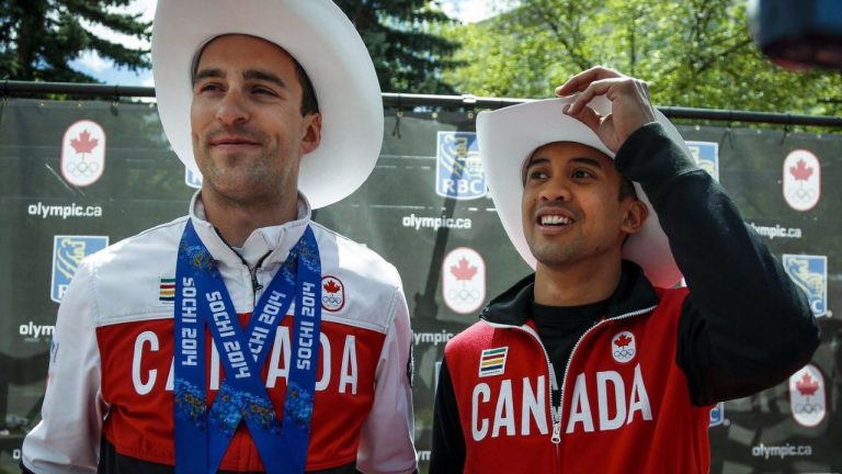 Sochi 2014 Olympians Denny Morrison, left, and Gilmore Junio take part in a Parade of Champions in Calgary, Alta., Friday, June 6, 2014. (THE CANADIAN PRESS/Jeff McIntosh)