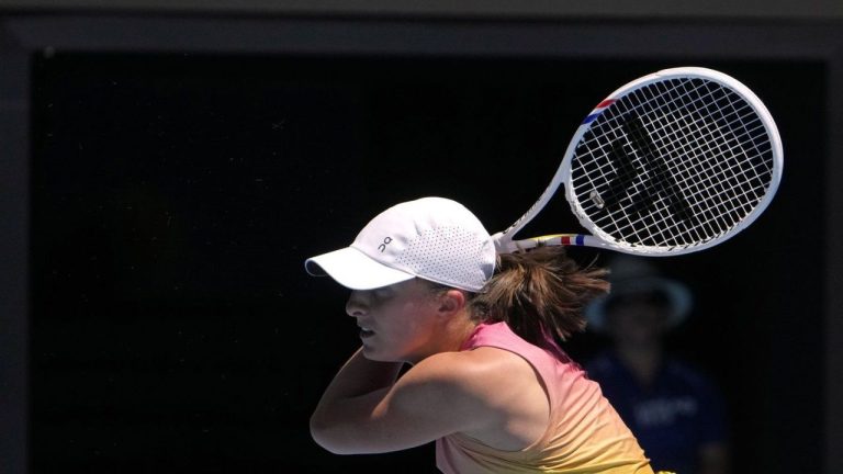 Iga Swiatek of Poland plays a backhand return to Rebecca Sramkova of Slovakia during their second round match at the Australian Open tennis championship in Melbourne, Australia, Thursday, Jan. 16, 2025. (Asanka Brendon Ratnayake/AP)