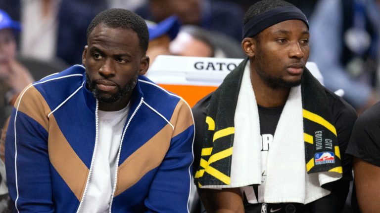 Golden State Warriors forwards Draymond Green, left, and Jonathan Kuminga watch the action from the bench during the first quarter of an NBA basketball game against the New Orleans Pelicans, Wednesday, Jan. 10, 2024, in San Francisco. (AP Photo/D. Ross Cameron)