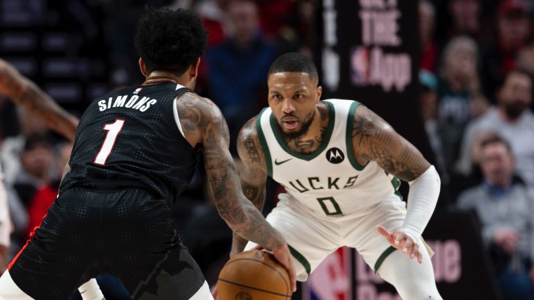 Portland Trail Blazers guard Anfernee Simons, left, dribbles the ball against Milwaukee Bucks guard Damian Lillard during the first half of an NBA basketball game, Tuesday, Jan. 28, 2025, in Portland, Ore. (Howard Lao/AP)
