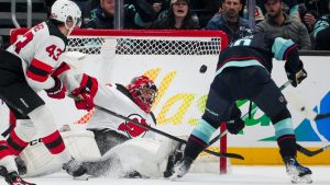 New Jersey Devils goaltender Jacob Markstrom blocks a shot from Seattle Kraken center Matty Beniers (10) during the third period of an NHL hockey game Monday, Jan. 6, 2025, in Seattle. (Lindsey Wasson/AP)