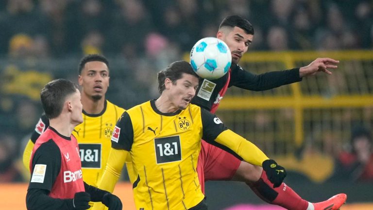 Dortmund's Marcel Sabitzer, centre, challenges for the ball with Leverkusen's Martim Terrier during the German Bundesliga soccer match between Borussia Dortmund and Bayer Leverkusen. (Martin Meissner/AP)