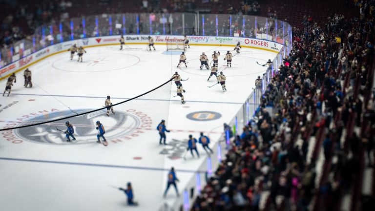 Fans watch the Montreal Victoire and the Toronto Sceptres warm up before a PWHL hockey game in Vancouver, in a photo taken with a tilt-shift lens, on Wednesday, January 8, 2025. (Ethan Cairns/CP)