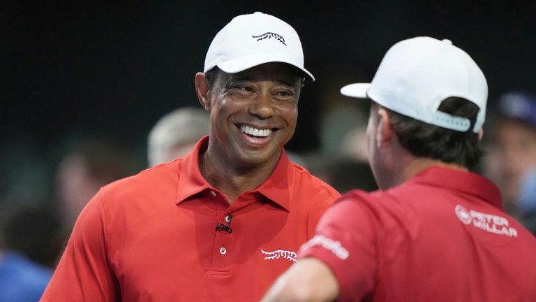 Tiger Woods talks to his Jupiter Links Golf Club teammate Kevin Kisner before the start of a match against the Los Angeles Golf Club, Tuesday, Jan. 14, 2025, in Palm Beach Gardens, Fla. (Marta Lavandier/AP)