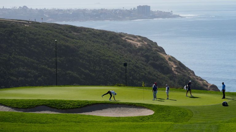 Nicolai Hojgaard, centre, prepares to putt on the third hole of the Sorth Course at Torrey Pines during the final round of the Farmers Insurance Open golf tournament, Saturday, Jan. 27, 2024, in San Diego. (AP/Gregory Bull)