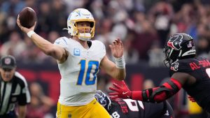Los Angeles Chargers quarterback Justin Herbert (10) throws a pass as Houston Texans' Azeez Al-Shaair pressures him during the first half of an NFL wild-card playoff football game Saturday, Jan. 11, 2025, in Houston. (Ashely Landis/AP Photo)