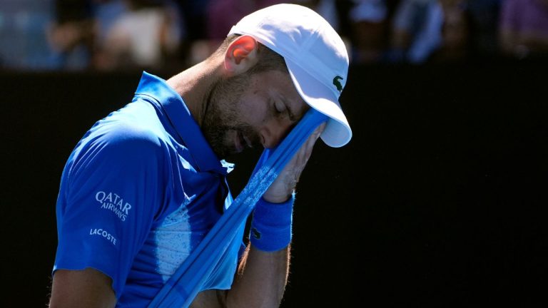 Novak Djokovic of Serbia wipes the sweat from his face during his semifinal match against Alexander Zverev of Germany at the Australian Open tennis championship in Melbourne, Australia, Friday, Jan. 24, 2025. (Asanka Brendon Ratnayake/AP)