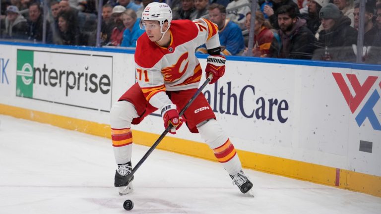 Calgary Flames' Walker Duehr (71) controls the puck during the first period of an NHL hockey game against the St. Louis Blues Tuesday, Jan. 14, 2025, in St. Louis. (Jeff Roberson/AP)