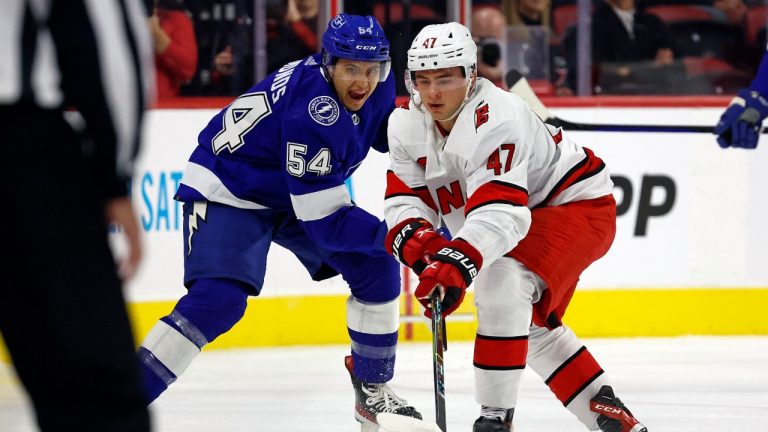 Carolina Hurricanes' Alexander Passion (47) battles with Tampa Bay Lightning's Lucas Edmonds (54) during the first period of an NHL preseason hockey game in Raleigh, N.C., Tuesday, Sept. 27, 2022. (Karl B DeBlaker/AP)