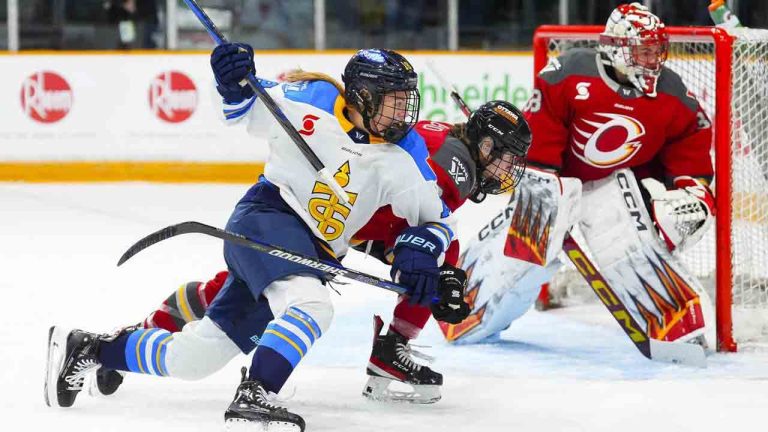 Ottawa Charge's Zoe Boyd (centre) chases the puck against Toronto Sceptres' Jesse Compher (left) as Ottawa Charge goaltender Emerance Maschmeyer (38) looks on during second period PWHL hockey action in Ottawa on Tuesday, Jan. 14, 2025. (Sean Kilpatrick/CP)