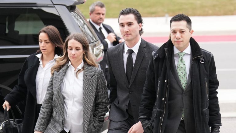 Alex Formenton, centre, a former team Canada world juniors hockey player arrives at court in London, Ont., Monday, Nov. 25, 2024. Five players accused of sexually assaulting a woman after a London, Ont., gala celebrating their 2018 world junior hockey win, are scheduled to stand trial on April 22. (Nathan Denette/THE CANADIAN PRESS)