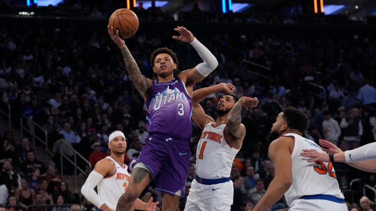 Utah Jazz's Keyonte George (3) drives past New York Knicks' Cameron Payne (1) and Karl-Anthony Towns (32) during the first half of an NBA basketball game Wednesday, Jan. 1, 2025, in New York. (Frank Franklin II/AP)