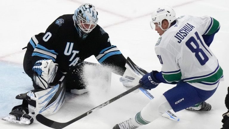 Vancouver Canucks center Dakota Joshua (81) scores against Utah Hockey Club goaltender Karel Vejmelka, left, during the third period of an NHL hockey game Wednesday, Dec. 18, 2024, in Salt Lake City. (Rick Bowmer/AP)