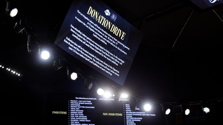 Signs announce the Los Angeles Lakers donation drive for California wildfires victims before an NBA basketball game against the San Antonio Spurs, Monday, Jan. 13, 2025, in Los Angeles. (Kevork Djansezian/AP)