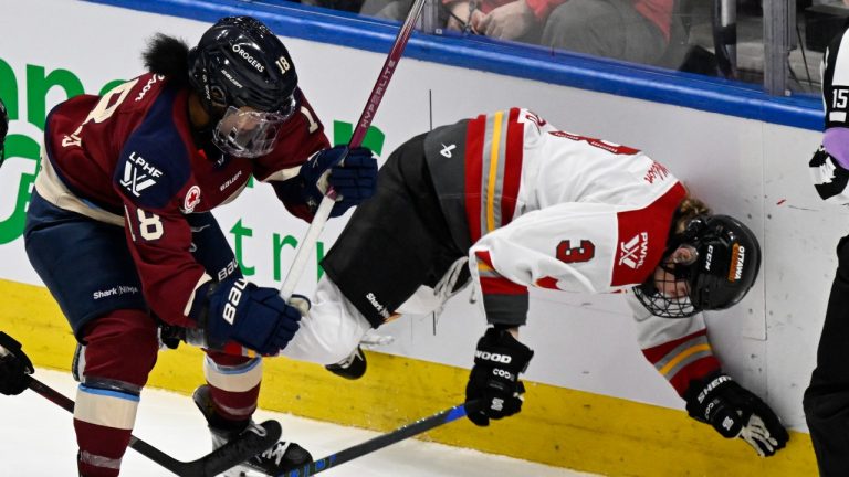 Ottawa Charge's Zoe Boyd falls forward after she is checked by Montreal Victoire's Mikyla Grant-Mentis during second period PWHL action in Quebec City, Sunday, January 19, 2025. (Jacques Boissinot/CP)