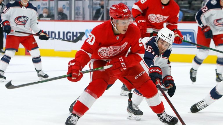 Columbus Blue Jackets Justin Scott (67) tries to block a shot Detroit Red Wings left wing Dominik Shine (50) during the first period of an NHL hockey game Saturday, Oct. 2, 2021, in Detroit. (Duane Burleson/AP)