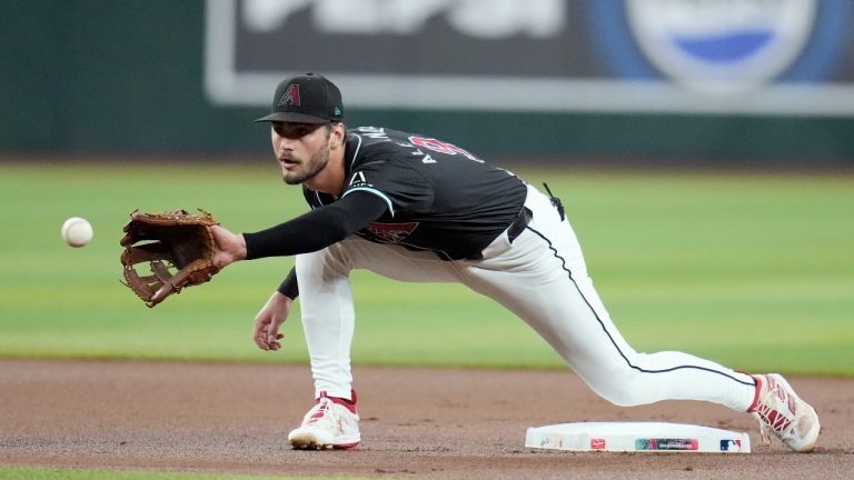 Arizona Diamondbacks second baseman Blaze Alexander warms up prior to a baseball game against the Colorado Rockies, Wednesday, Aug. 14, 2024, in Phoenix. (AP Photo/Ross D. Franklin)