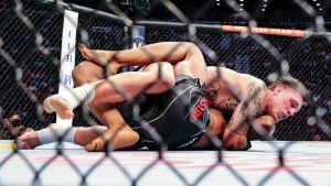 Brendan Allen, top, looks for a submission hold on Karl Roberson during a UFC 261 mixed martial arts bout, Saturday, April 24, 2021, in Jacksonville, Fla. It is the first UFC event since the onset of the COVID-19 pandemic to feature a full crowd in attendance. (AP Photo/Gary McCullough)