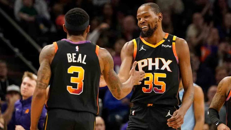 Phoenix Suns guard Bradley Beal (3) Kevin Durant (35) slap hands during the first half of an NBA basketball game against the Memphis Grizzlies Tuesday, Dec. 31, 2024, in Phoenix. (Darryl Webb/AP)