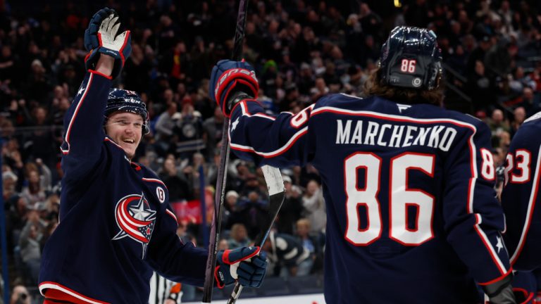 Columbus Blue Jackets' Dmitri Voronkov, left, congratulates Kirill Marchenko on his goal against the St. Louis Blues during the second period of an NHL hockey game Saturday, Jan. 4, 2025, in Columbus, Ohio. (AP Photo/Jay LaPrete)