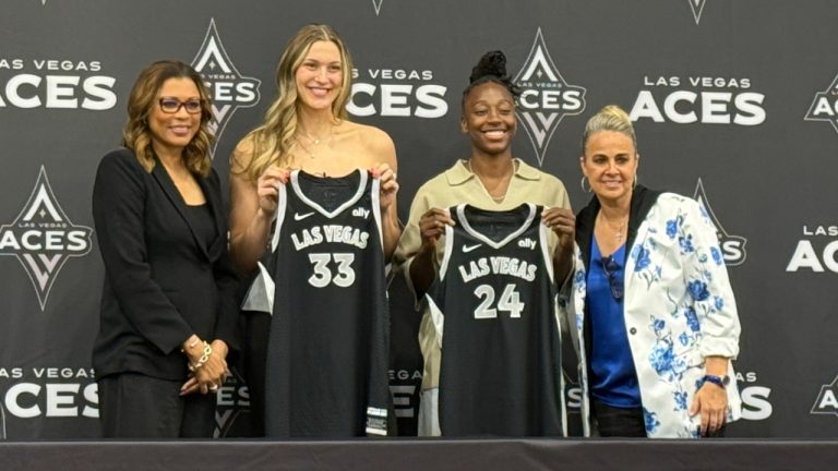 Las Vegas Aces' Liz Kitley, center left, and Jewell Loyd, center right, pose for a photo alongside President Nikki Fargas, left, and Becky Hammon at a presser in Las Vegas, Tuesday, Feb. 25, 2025. (AP Photo/Mark Anderson)