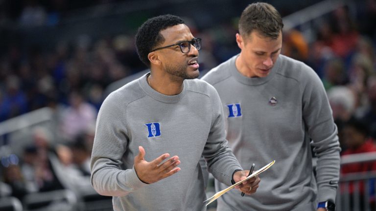 Duke associate head coach Jai Lucas, left, and head coach Jon Scheyer work during the first half of a first-round college basketball game against Oral Roberts in the NCAA Tournament, March 16, 2023, in Orlando, Fla. (Phelan M. Ebenhack/AP)