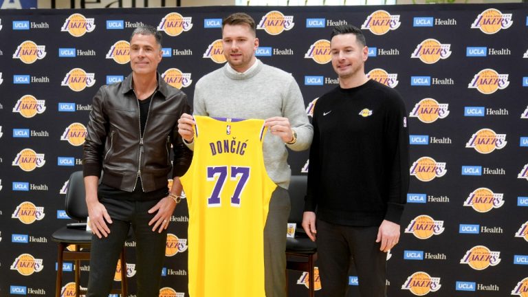 From left to right, Los Angeles Lakers general manager Rob Pelinka, Luka Doncic, and head coach JJ Redick pose for photos during an introductory NBA basketball press conference Tuesday, Feb. 4, 2025, in El Segundo, Calif. (Jae C. Hong/AP)