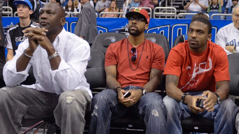 Michael Jordan, left, with his sons Marcus, center, and Jeffrey, watch an NBA basketball game in Orlando, Fla., Sunday, Feb. 27, 2011. (Phelan M. Ebenhack/AP)