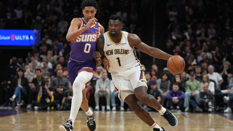 New Orleans Pelicans forward Zion Williamson (1) drives past Phoenix Suns forward Ryan Dunn during the first half of an NBA basketball game, Thursday, Feb. 27, 2025, in Phoenix. (AP Photo/Rick Scuteri)