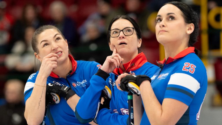 Manitoba skip Kerri Einarson (centre) and teammates Karlee Burgess (left) and Krysten Karwacki watch the measurement on the scoreboard as they give up 3 in the first end to Manitoba's Cameron during Scotties Tournament of Hearts action in Thunder Bay, Ont., Tuesday, Feb. 18, 2025. (Frank Gunn/CP)