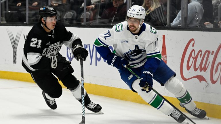 Vancouver Canucks centre Filip Chytil (72) controls the puck with Los Angeles Kings defenseman Jordan Spence (21) defendingduring the first period of an NHL hockey game in Los Angeles, Wednesday, Feb. 26, 2025. (Alex Gallardo/AP)
