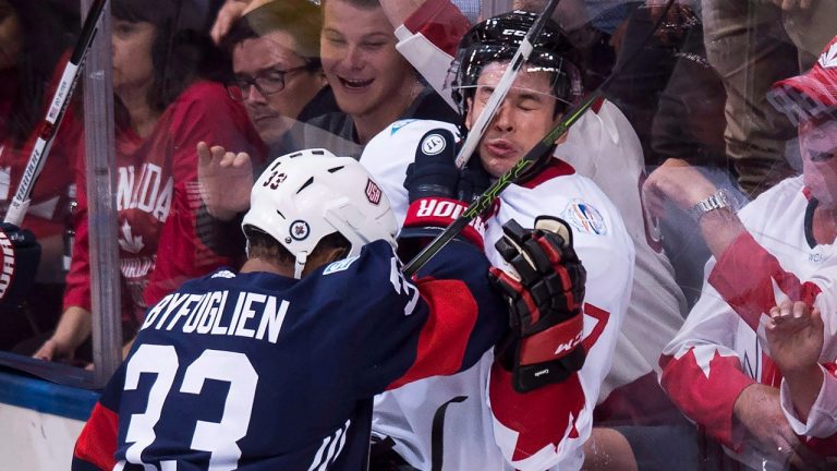 Team Canada centre Sidney Crosby (87) gets hit by Team USA defenceman Dustin Byfuglien (33) during second period World Cup of Hockey action in Toronto on Tuesday, September 20, 2016. (Nathan Denette/CP)