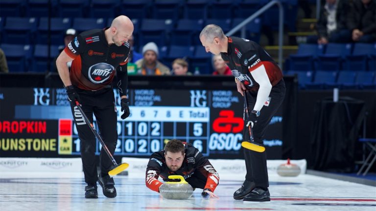 Matt Dunstone (centre) shoots a stone as Ryan Harnden (left) and E.J. Harnden (right) prepare to sweep during the WFG Masters on Jan. 18, 2025, in Guelph, Ont. (Anil Mungal/GSOC)