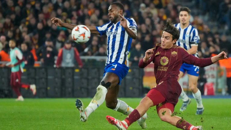 Porto's Otavio, left, tries to block a shot from Roma's Paulo Dybala during the Europa League playoff second leg soccer match between Roma and Porto at the Stadio Olimpico in Rome, Italy, Thursday, Feb. 20, 2025. (Gregorio Borgia/AP)