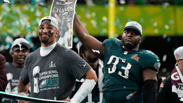 Philadelphia Eagles quarterback Jalen Hurts smiles on the podium next to defensive tackle Milton Williams (93) after a win over the Kansas City Chiefs during the NFL Super Bowl 59 football game, Sunday, Feb. 9, 2025, in New Orleans. (Matt Slocum/AP)